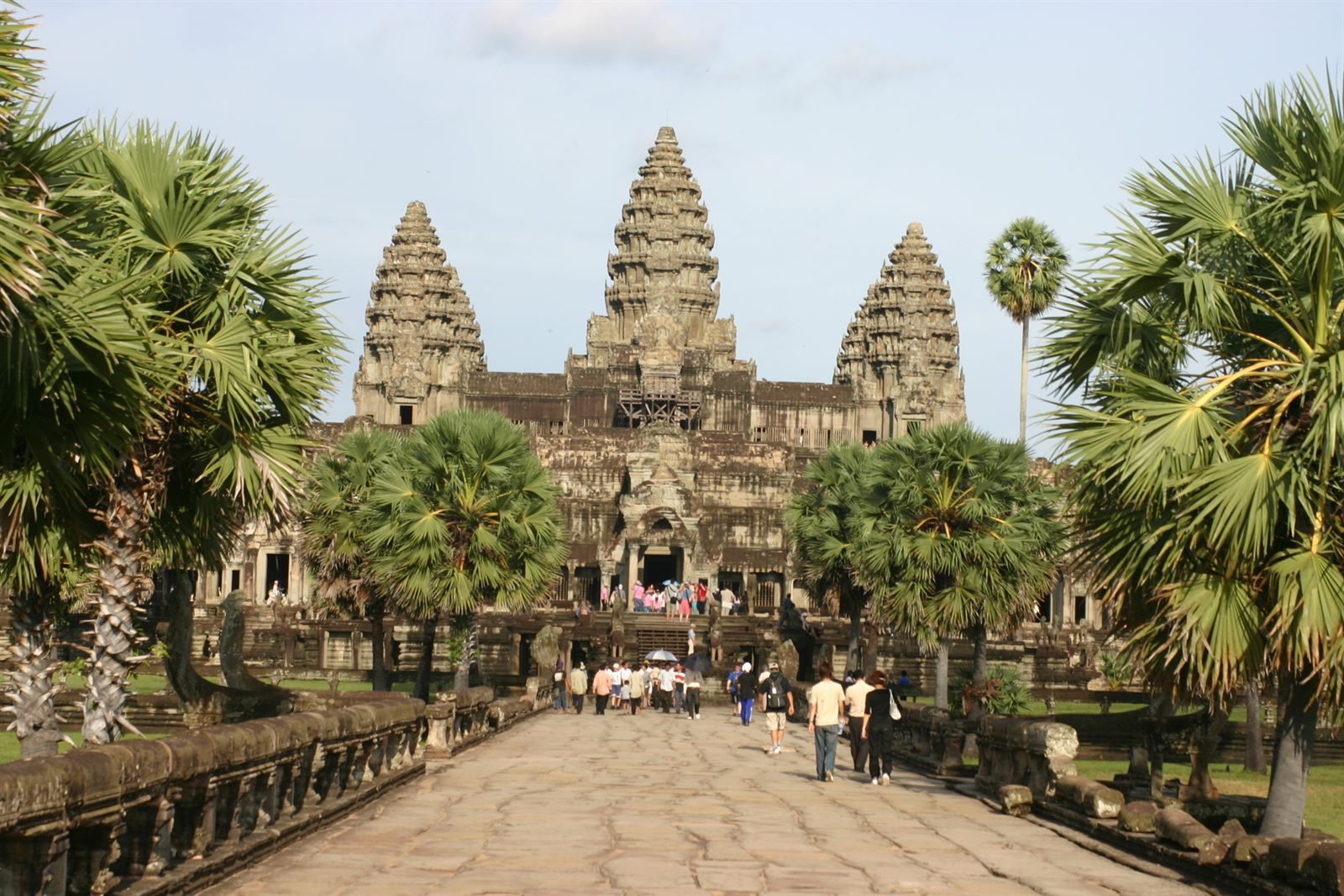 Causeway to the towers of Angkor Wat framed by palm trees, Siem Reap
