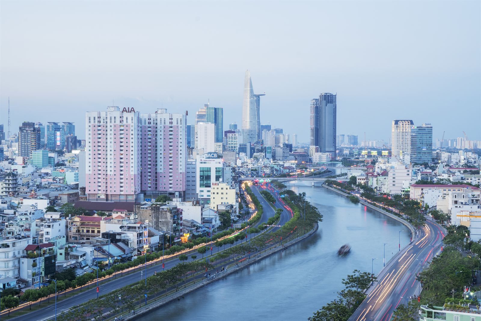 Ho Chi Minh City skyline and canal-side boulevards at dusk