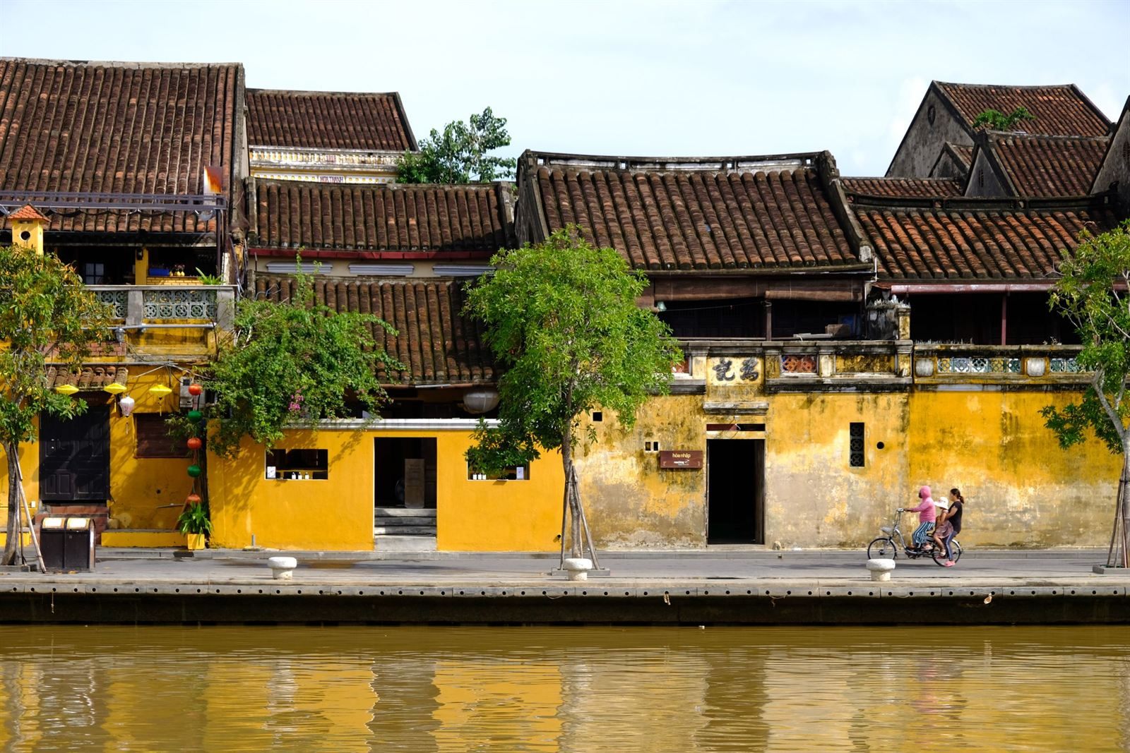 Mustard-yellow shophouses along the Thu Bon riverfront in Hoi An Ancient Town