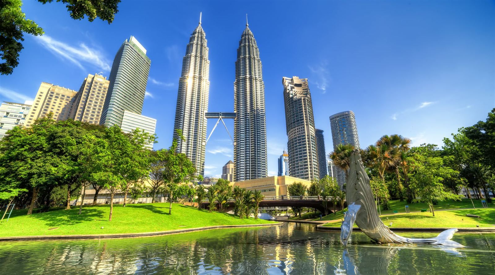 Petronas Twin Towers rising above the lake and gardens of KLCC Park, Kuala Lumpur