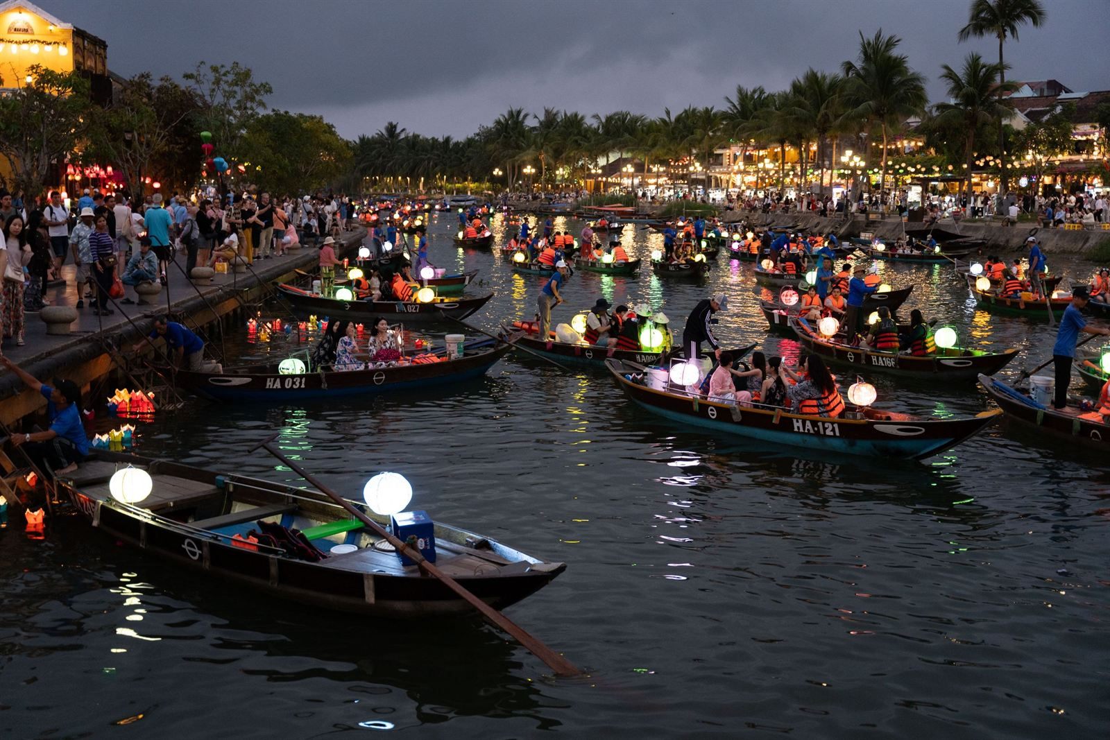 Lantern-lit boats on the Thu Bon River at dusk in Hoi An